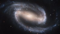 Barred spiral galaxy in space. Represents science and philosophy.